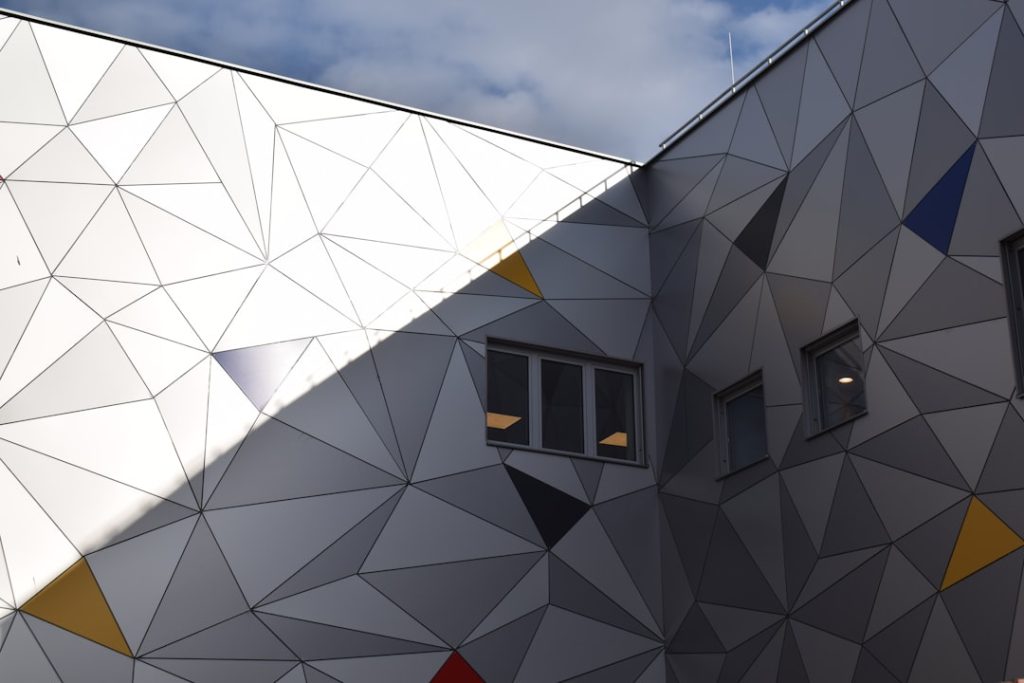 Mastering the First Impression: Your intriguing post title goes here a-building-with-a-triangular-design-on-the-side-of-it-fobkp-xrgxm