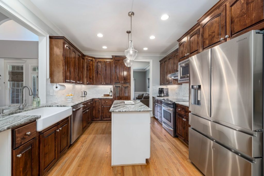 The Art of Drawing Readers In: Your attractive post title goes here Spacious modern kitchen featuring wooden cabinets and stainless steel appliances with elegant lighting.