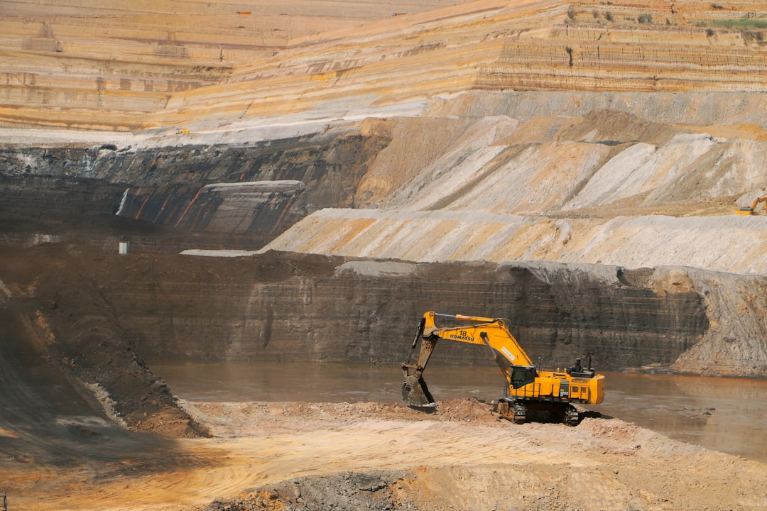 contact-img a-yellow-excavator-in-a-large-open-pit-1o-hnwey0o4