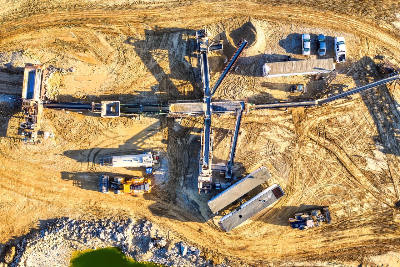 engagement-photography-03 Drone capture of an industrial mining site in Rochester, showcasing heavy machinery and equipment.