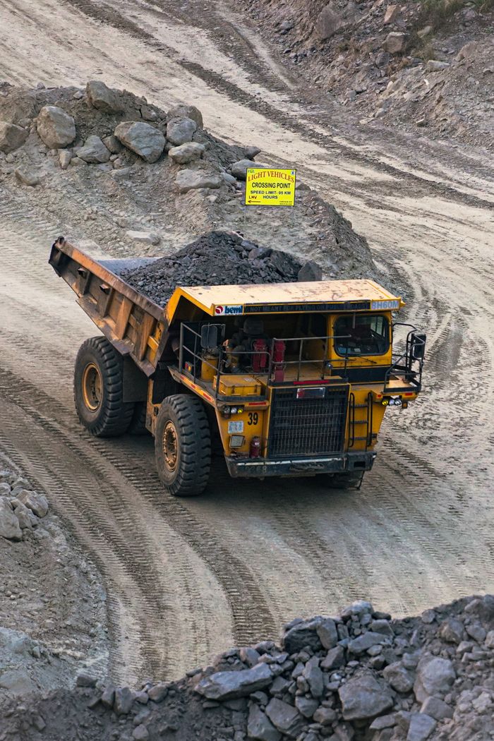 featured-images-03 Heavy mining truck transporting minerals in a rocky open-pit quarry in Bahula, West Bengal.
